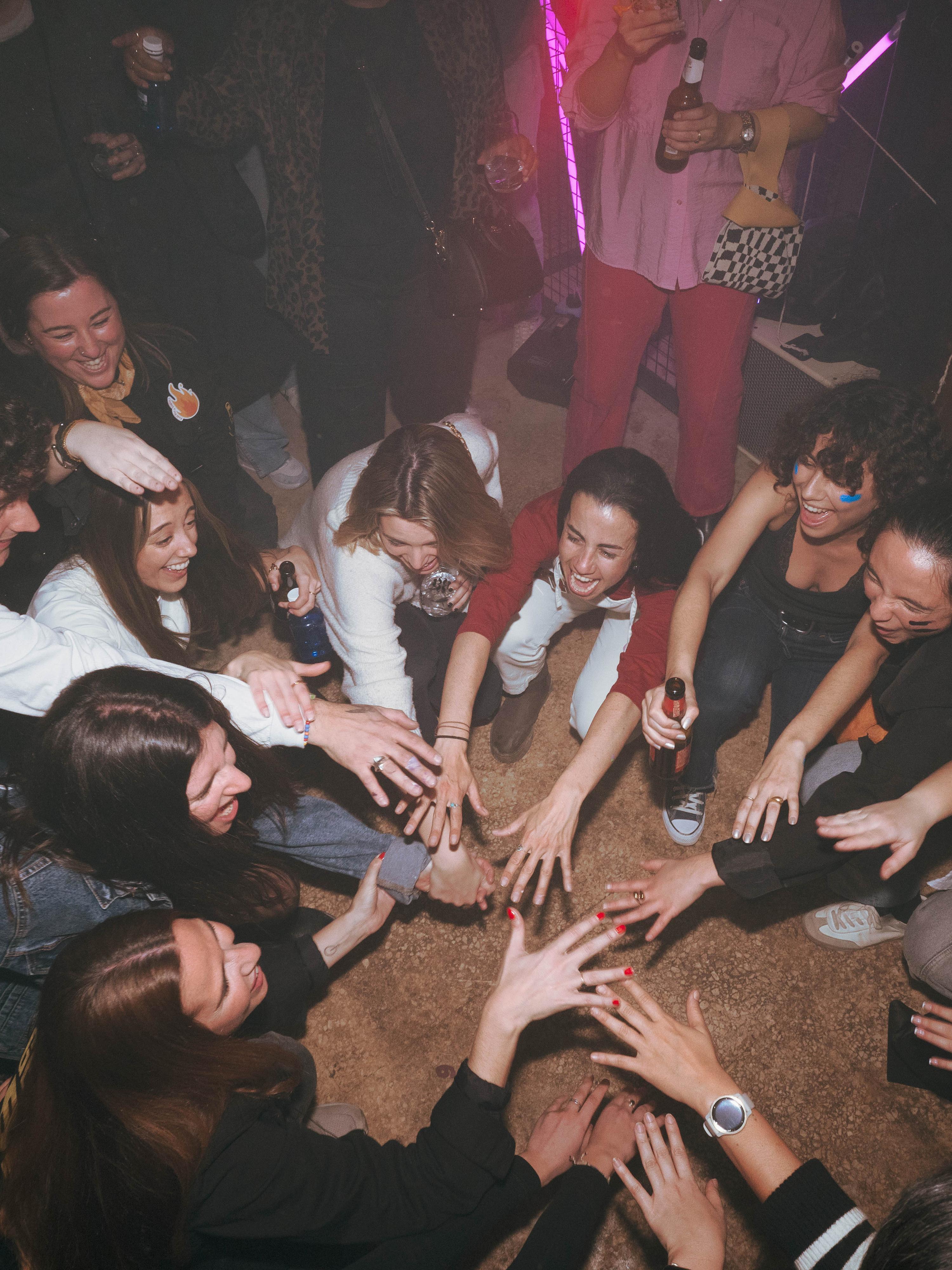 A group joining hands at a party